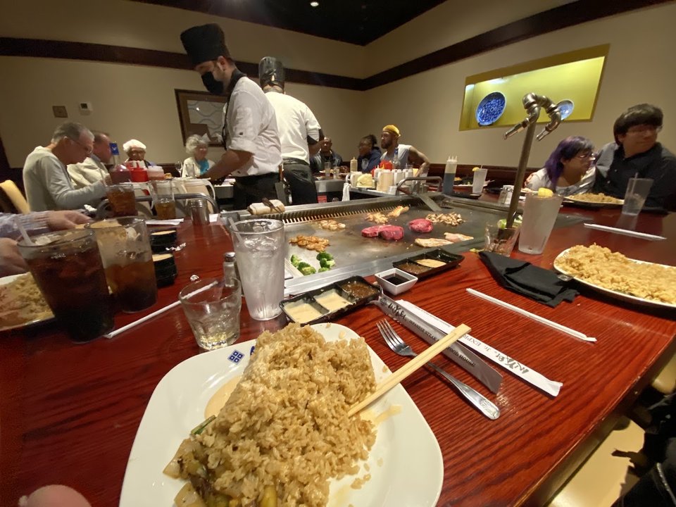 Dining room with hibachi tables and warm lighting.